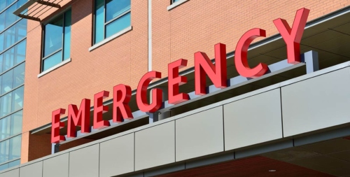 The exterior of a hospital's Emergency Room that may be experiencing internal security threats.